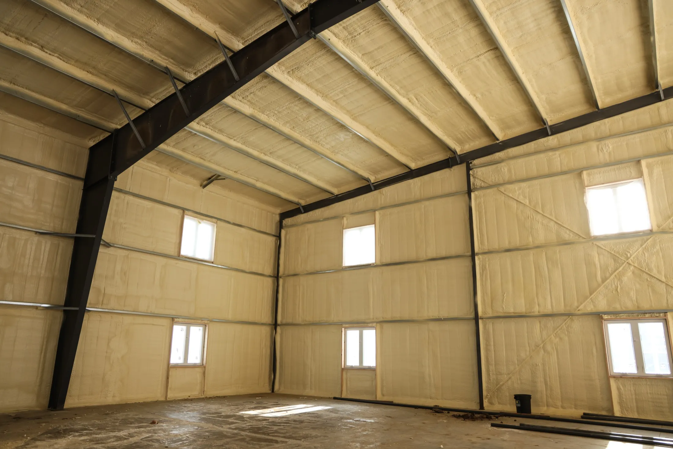 Wall cavity spray foam application